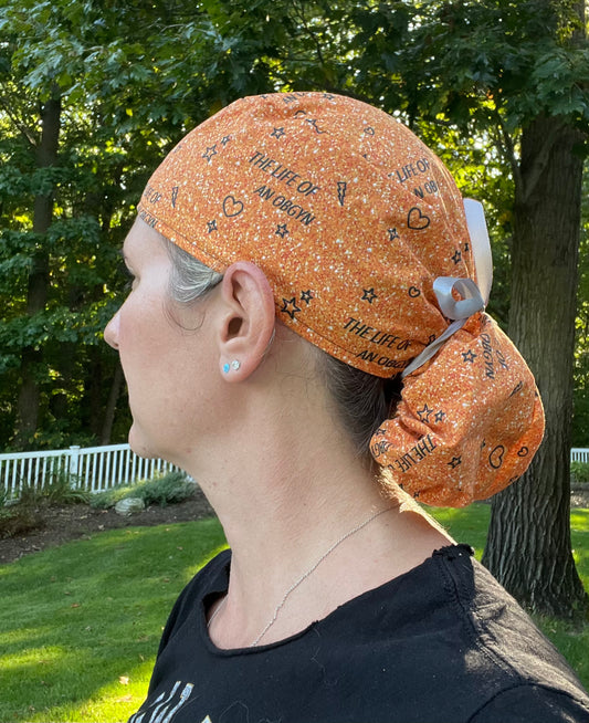 Taylor Swift life of an OBGYN orange glitter print ponytail scrub cap womens