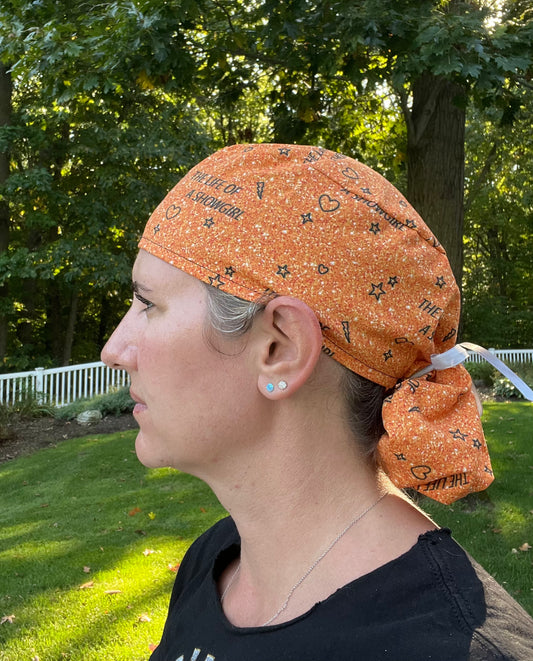 Taylor Swift life of a SHOWGIRL orange glitter print ponytail scrub cap womens